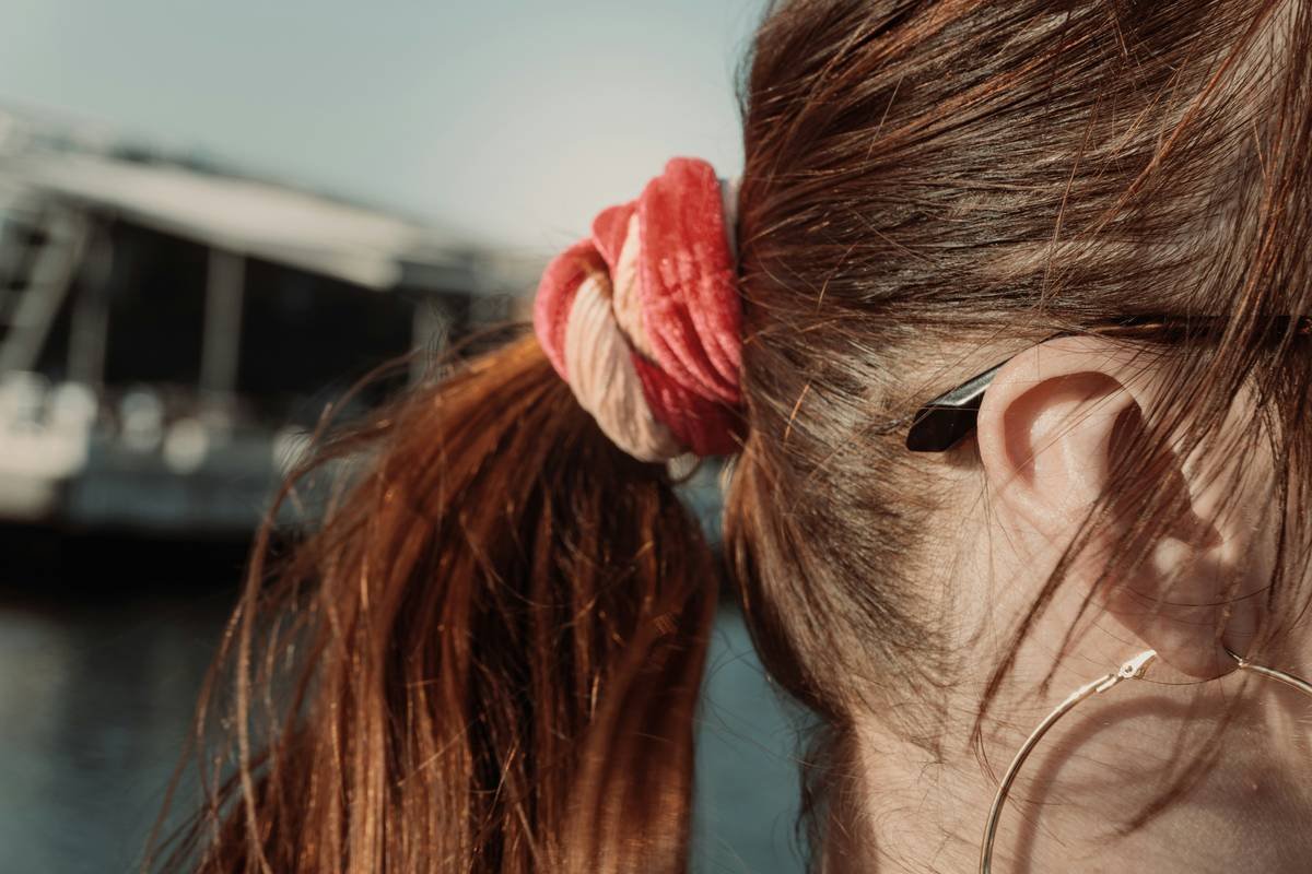 Diagram comparing high-tension vs. low-tension ponytail styles showing reduced stress points on hair follicles