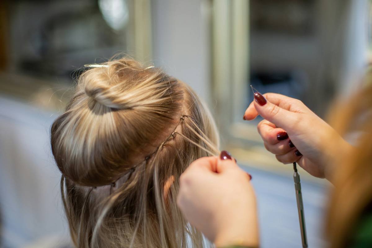 ponytail extension tips showing proper clip placement on textured natural hair
